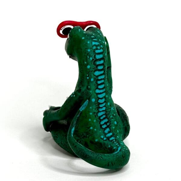 Handmade Jurassic Zubaloo velociraptor in green polymer clay with leaves